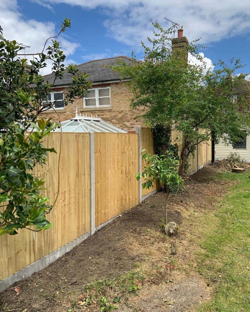 This is a photo of fence panels installed in a residential garden using concrete posts and gravel boards. Installed by Fast Fix Fencing Chatteris
